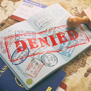 Passport with a denied stamp representing denied Visa - Serving Immigrants