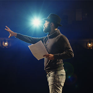 A man holding a paper and pointing to the side - Serving Immigrants