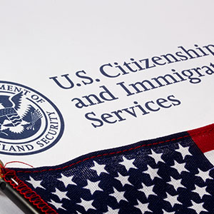 US Citizenship and Immigration Services logo - Serving Immigrants