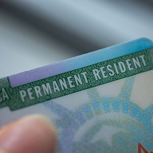 A man holding a card - Serving Immigrants