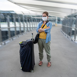 A women standing with a luggage - Serving Immigrants