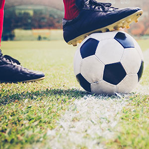 A football ball on a field - Serving Immigrants