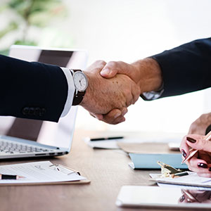 Two persons shaking hands - Serving Immigrants