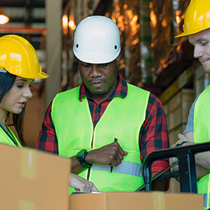 A group of workers in a warehouse - Serving Immigrants