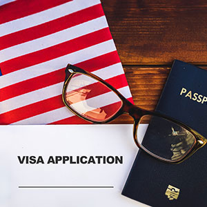 A passport and glasses on a table - Serving Immigrants