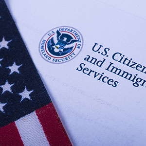 Close-up of a document with a flag - Serving Immigrants