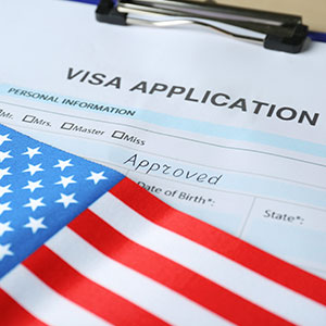 Visa application on a clipboard - Serving Immigrants