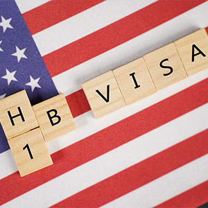 Image of H1B visa with American flag - Serving Immigrants