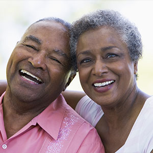 A man and woman joyfully laughing - Serving Immigrants