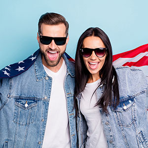 A men and women holding a flag - Serving Immigrants