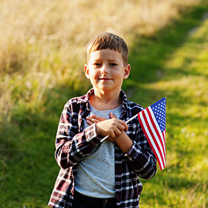A child holding a flag - Serving Immigrants