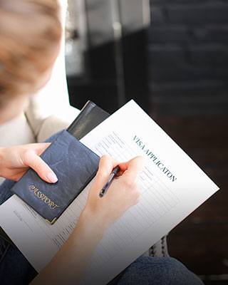 Woman on sofa with passport and notebook - Serving Immigrants