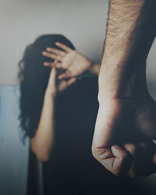 A women covering their face with their hand, expressing emotions - Serving Immigrants