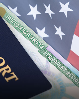 A US visa and passport on a table - Serving Immigrants